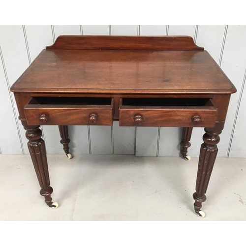 115 - An Edwardian ladies writing desk, with two drawers, raised on by tapered legs with castors. Dimensio... 