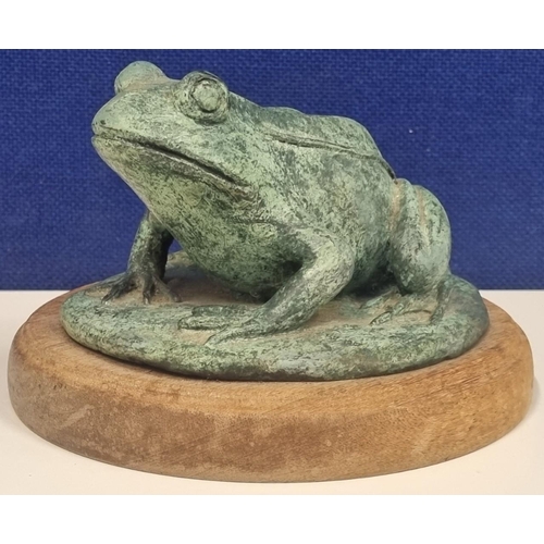 466 - A heavy, verdigris bronze frog figure, mounted on a wooden plinth. Signed, with a maker's mark 'JC'.... 