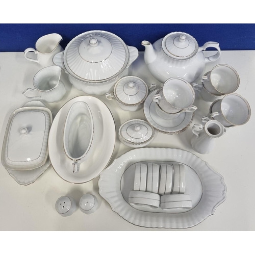 534D - A substantial 'Chodziez', Poland, white china dinner service. Includes a lidded vegetable dish, teap... 