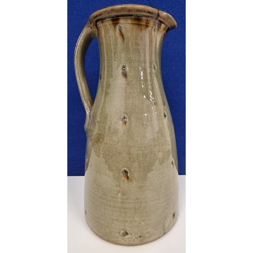 524 - A substantial studio pottery ceramic baluster jug, with a muted green craquelure glaze, by John Jelf... 