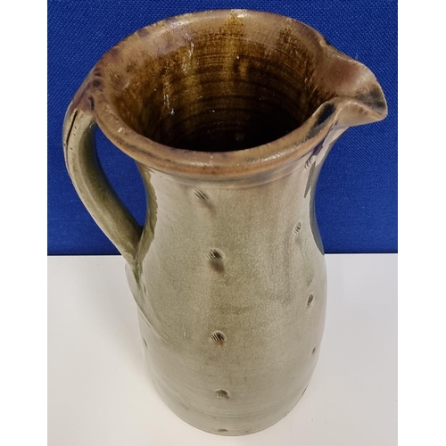 524 - A substantial studio pottery ceramic baluster jug, with a muted green craquelure glaze, by John Jelf... 