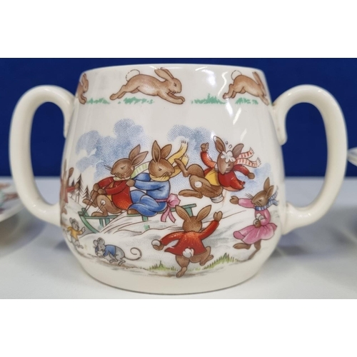 599 - A three-piece set of 'Royal Doulton' 'Bunnykins' nursery ware. Consists of a double handled cup, bow... 