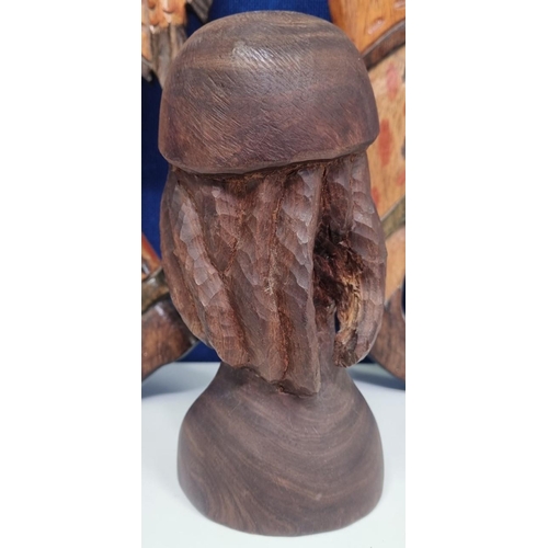 629 - A trio of treen tourist pieces, to include a good looking male bust & two wall plaques. The longest ... 