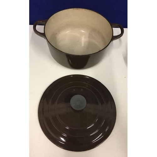 684 - A 'Le Creuset', brown cast iron casserole pot, size D, together with a copper casserole dish.