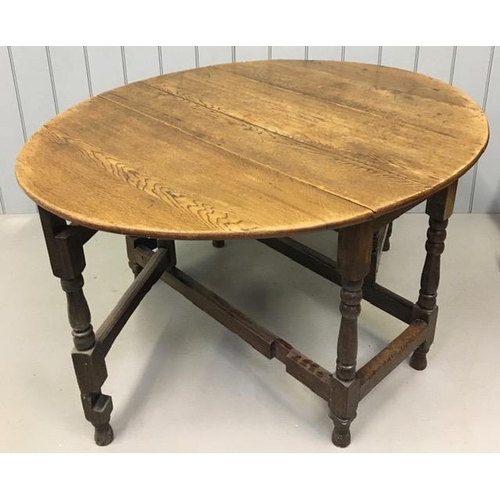 1 - An antique, oval oak gateleg table. Dimensions(cm) H76, W54/143, D116.