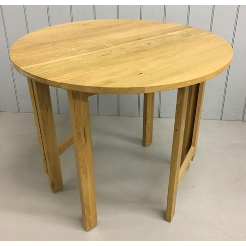 11 - A contemporary, beech, gateleg/drop leaf kitchen table. Dimensions(cm) H76, W90, D46/90.