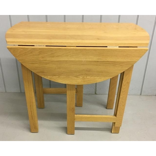 12 - A contemporary, beech, gateleg/drop leaf kitchen table. Dimensions(cm) H76, W90, D46/90.