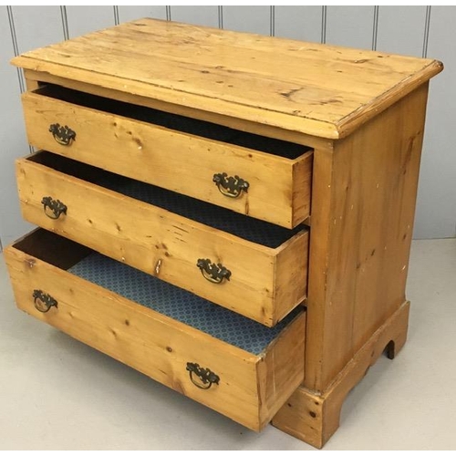 66 - An antique, solid pine chest of three drawers, with brass handles. Dimensions(cm) H78, W92, D49.