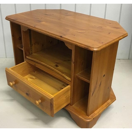 134 - A pine, corner TV cabinet. Dimensions(cm) H61, W85, D49.