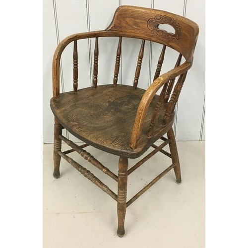 141 - An early 20th century, elm captain's chair, featuring a pierced handle collar, on turned spindles & ... 