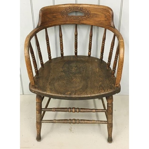 141 - An early 20th century, elm captain's chair, featuring a pierced handle collar, on turned spindles & ... 