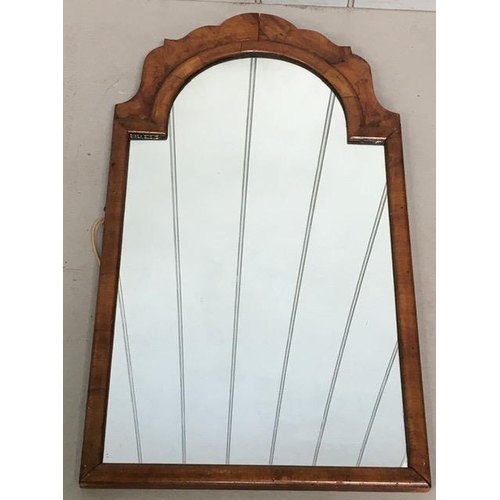 173 - An early 1900's walnut framed, crest-top mirror. Dimensions(cm) H68, W43