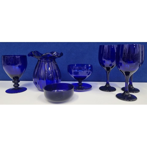 209 - A group of 'Bristol Blue' style vintage glassware, to include three wine glasses, a rummer, a finger... 