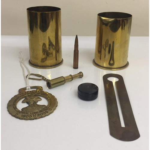 269 - A selection of brass militaria items. Includes button-cleaning uniform protector, WW1 shell cases (F... 