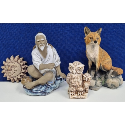 493B - A collection of four eclectic figurines, to include a Chinese mud man, a 'Border Fine Arts' fox & tw... 