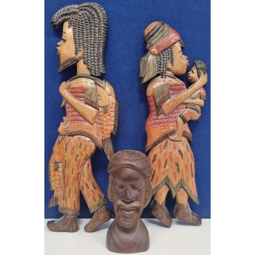 629 - A trio of treen tourist pieces, to include a good looking male bust & two wall plaques. The longest ... 