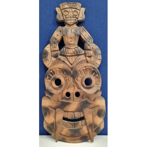 658 - A mid-20th century, hand-carved wooden totem style mask with charred pattern to face. Likely Tiki. D... 