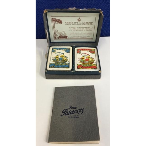 771 - An original twin set of Orient Line playing cards, in presentation box & games book.