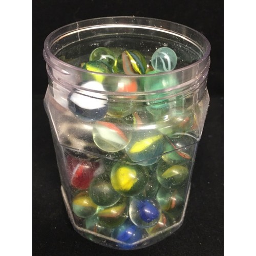 1964 - A jar of early 20th century marbles.