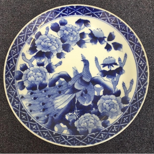 497 - A Chinese, blue & white plate, with Peacock & floral decoration. Diameter 26cm.