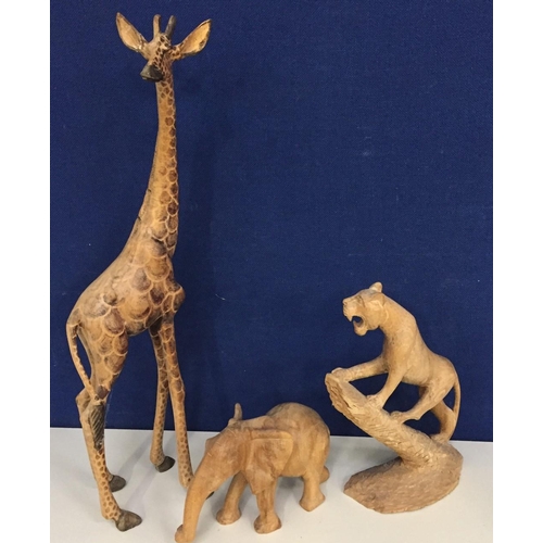 627 - Three vintage carved animal figures. Includes giraffe (repaired ear), elephant & leopard.