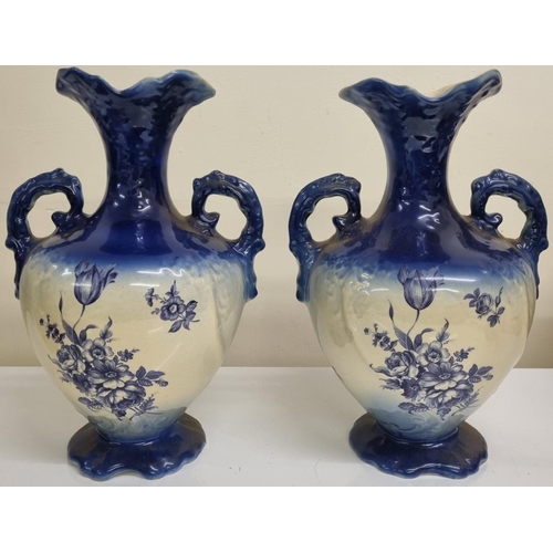 488 - A pair of double handled, urn-style vases, with a blue floral transfer print design, likely 'Oldcour... 