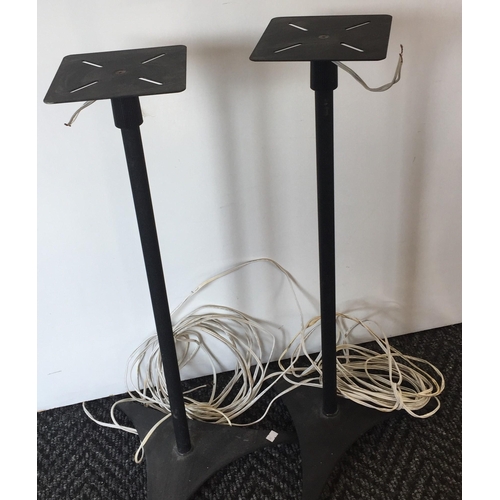 3106 - A pair of triangular-based speaker stands, with lengths of speaker cable.