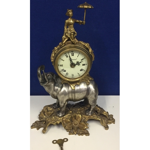 An Italian 'Brevettato' brass & bronze elephant mantel clock. The top heightened by a Chinese figure holding a parasol. The clock face marked 'Imperial' & mounted on an elephant figure. The base is stamped with the maker's mark & serial no. 7093-B/77. Dimensions(cm) H40, W30, D17.