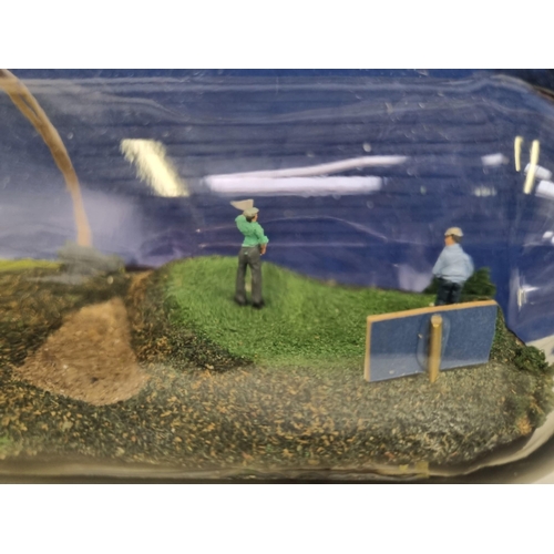 643 - A hand-made, artisan golfing theme diorama inside a whisky bottle (originally presented as an award ... 