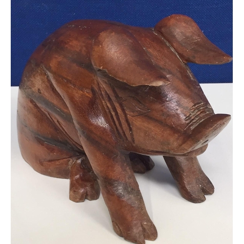 684 - A hand-carved pig figure. Height 17cm, length 24cm.