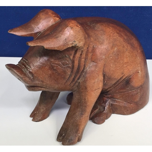 684 - A hand-carved pig figure. Height 17cm, length 24cm.