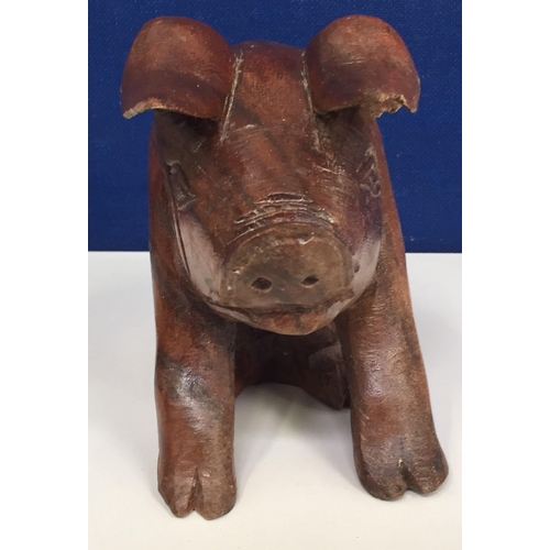 684 - A hand-carved pig figure. Height 17cm, length 24cm.