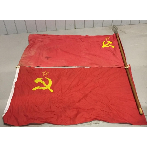 705 - A pair of vintage USSR flags, one on flagpole with hammer & sickle topper.
Flagpole 170cm. Flag leng... 