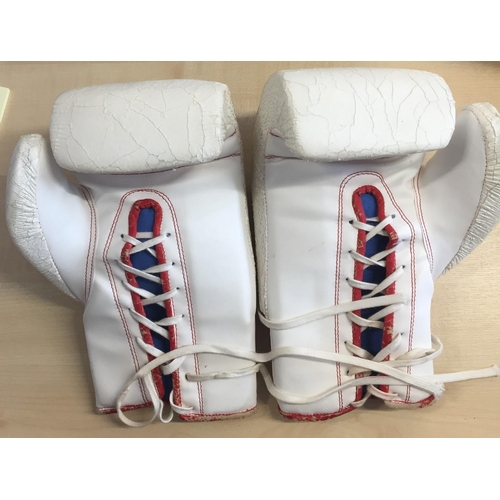 733 - A pair of Lonsdale boxing gloves, appearing worn & bearing the autograph of Henry Cooper (1934-2011)... 