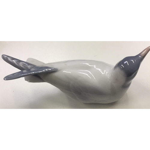 586 - A 'Royal Copenhagen' Gull figure, no.1468. Minor tail damage. Height 6cm, length 13cm.