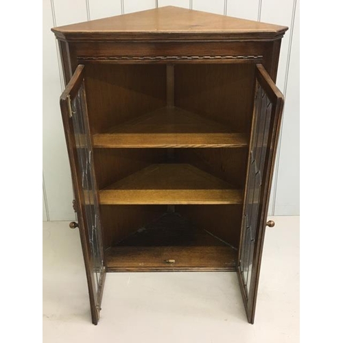 82 - An oak, glazed corner display bookcase, by Bevan Funnell. Ltd. Dimensions(cm) H108, W80, D45.