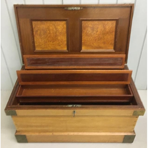 85 - A brass mounted, camphor military campaign chest. Hinged lid with walnut panels. Fully fitted interi... 