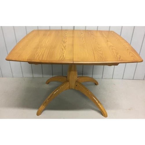 117 - An Ercol Windsor, extending pedestal dining table. Extension leaf housed on mechanism beneath tablet... 