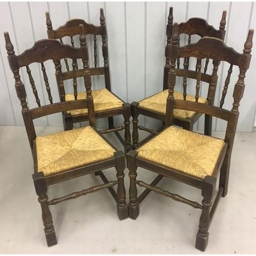 145A - A set of four oak/rush-reed chairs. Dimensions(cm) H104(44 to seat), W46, D50.