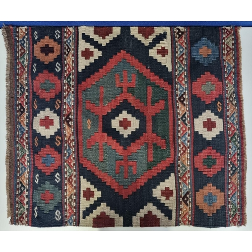 189 - Likely Caucasian, smaller vintage wool rug, with an abstract flowerhead design. Dimensions(cm) L70, ... 