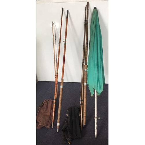 743 - Three vintage, cane fishing rods, together with a fishing umbrella. To include a 'Sydney Jarvis' thr... 