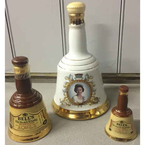 239 - Three 'Bell's Old Scotch Whisky' decanters, by 'Wade'. To include Queen's 60th Birthday commemorativ... 