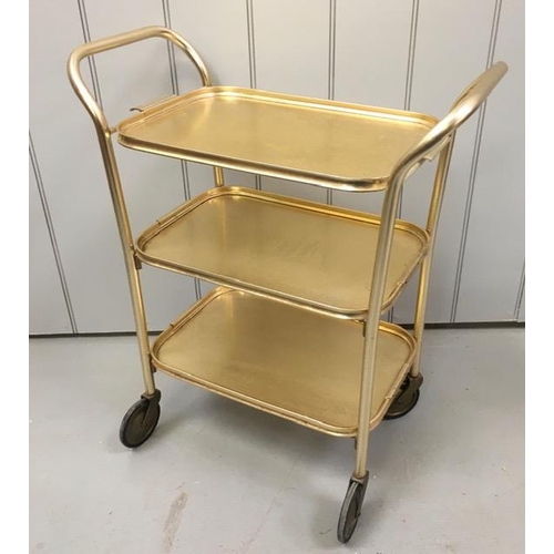 127 - A vintage, gold-coloured tea trolley, with three shelves. Dimensions(cm) H74, W63, D31.