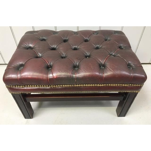 159 - A Chesterfield footstool, upholstered in oxblood-red leather. Dimensions(cm) H38, W65, D44.