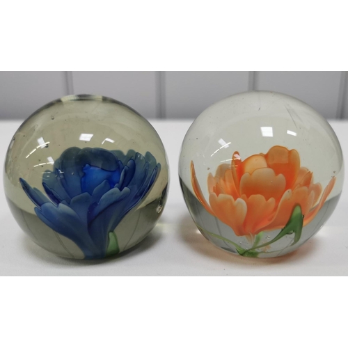 209 - A collection of twelve good quality glass paperweights, with a variety of patterns.