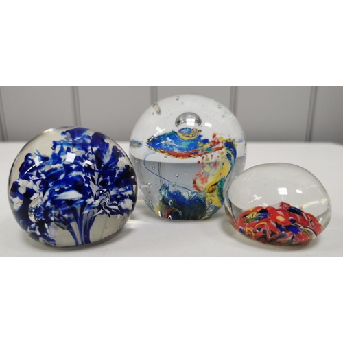 209 - A collection of twelve good quality glass paperweights, with a variety of patterns.