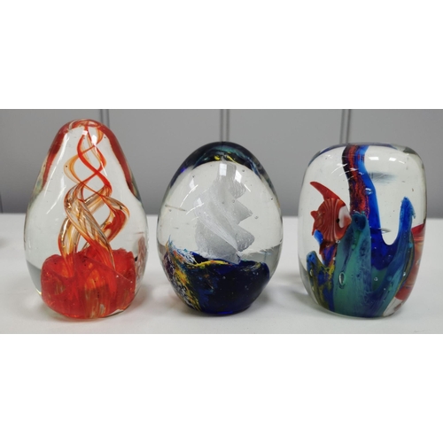 210 - A collection of twelve good quality glass paperweights, with a variety of patterns.