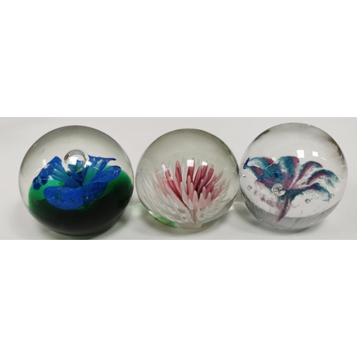 210 - A collection of twelve good quality glass paperweights, with a variety of patterns.