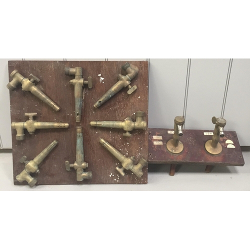 253 - Two display-mounted collections of brass barrel-taps.