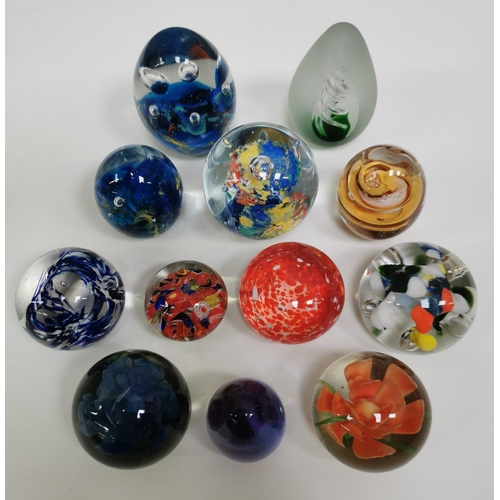 209 - A collection of twelve good quality glass paperweights, with a variety of patterns.